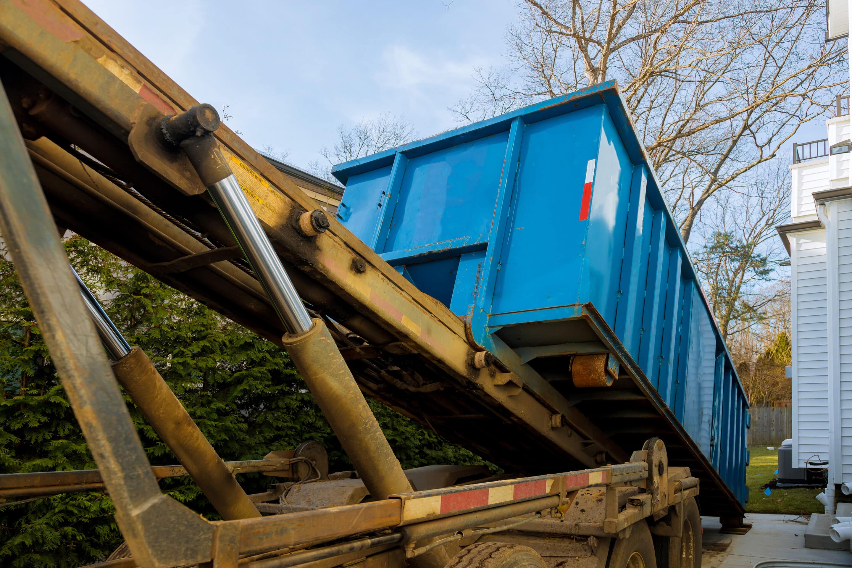 unloading empty open top dumpster